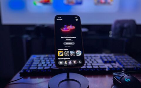 A stylish gaming setup featuring a smartphone on a stand with a vibrant display, keyboard, and mouse.